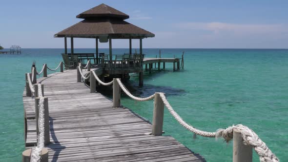 A beautiful gazebo on a pier in the open ocean in Asia. CROP TILT