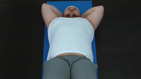 Oversize Tired Man Doing Abdominal Crunches, Lazy Sedentary Lifestyle, Body Care