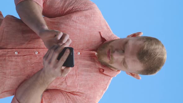 Young Man Chatting on Smartphone