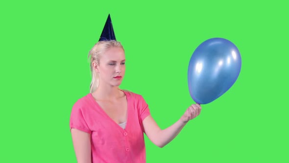 Female putting needle in balloon