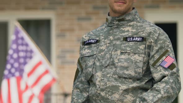 American Soldier Showing House Key Standing Outside Building