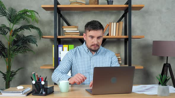 Businessman work laptop watching online video call meeting, blinks quickly eyes