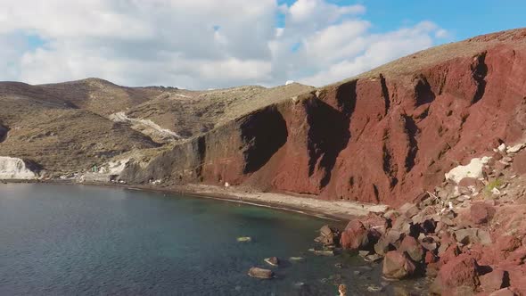 4k Drone aerial view of the beautiful Red Beach in Santorini