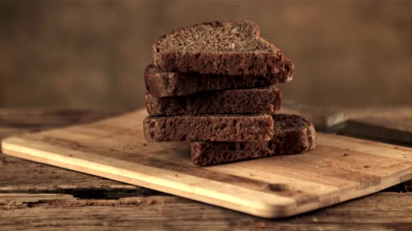 Super Slow Motion on the Cutting Board Fall Pieces of Bread