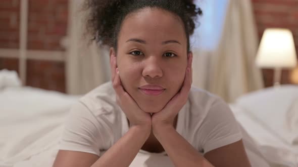 Portrait of African Woman Looking at the Camera in Bedroom