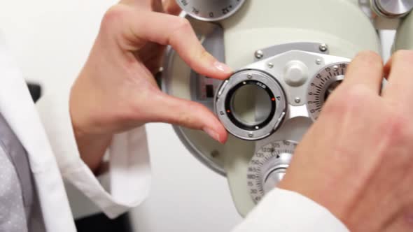 Female Optometrist Adjusting Chiropter