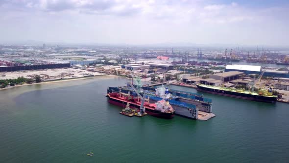 Aerial view of logistics concept a cargo ship being retrofit, repair and services on a floating dry