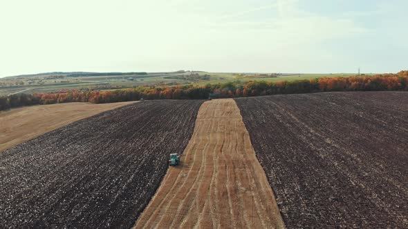 A View of Fields and Sky - Tractors Plows the Field