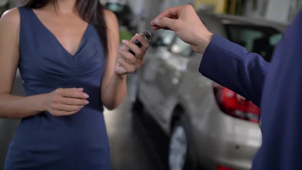 Handing Over Car Keys at Automobile Dealership