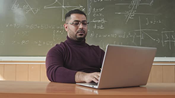 Portrait of Male Maths Professor with Laptop