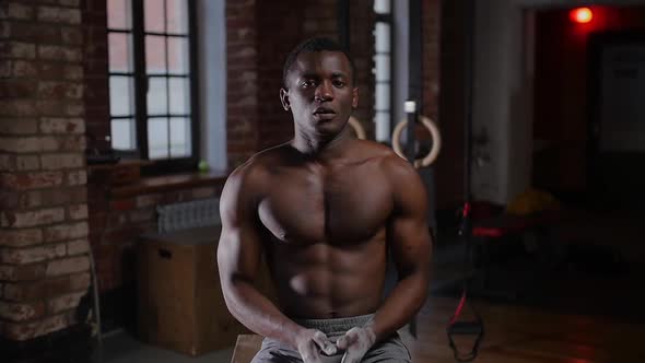 A Black Handsome Man Training in the Gym  Covering Hands in Chalk and Clapping Hands