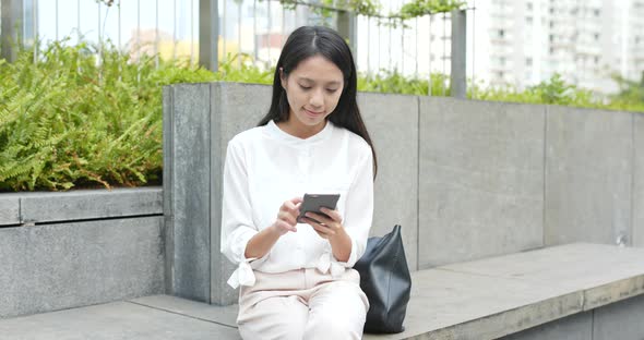 Business woman use of smart phone in city