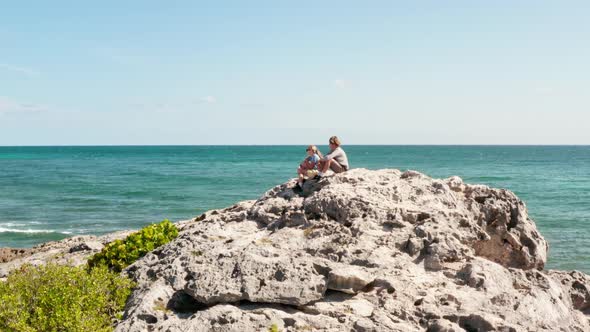 Children Sitting on a Rock Mexico