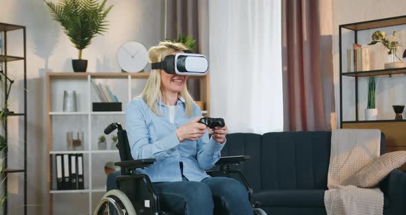 Disabled Woman in Wheelchair in Augmented Reality Goggles Enjoying Videogames