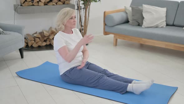 Old Woman Doing Stretches on Yoga Mat at Home