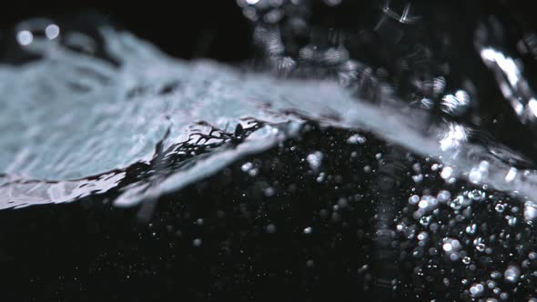 Super Slowmotion Shot of Water Wave Against Black