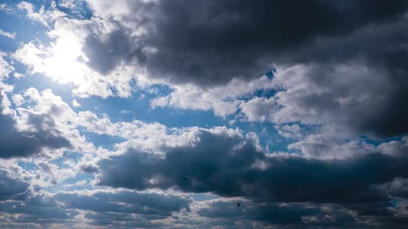 Timelapse of Gray Cumulus Clouds Moves in Blue Sky