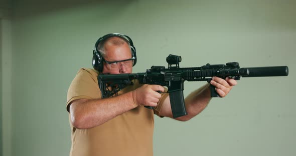 The Stressed Student Fires the First Shot From the Rifle at the Shooting Range