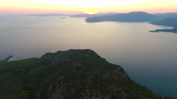 Morning Sunrise Over Forested Hills on the Seashore