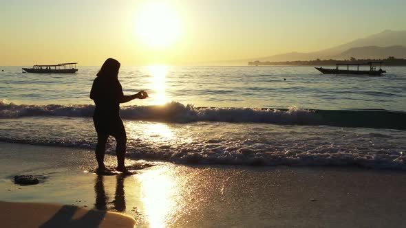 Lady alone enjoys life on perfect tourist beach trip by blue ocean and white sand background of the 