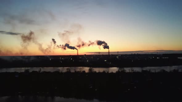 Smoking Stack in Sunrise. Air Pollution and Climate Change Theme. Poor Environment in the City