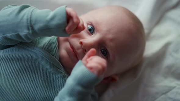 Little Toddler Boy Whit Blue Eye Smiling at Camera Boy Laughing and Happy in Bed Toy Overhead