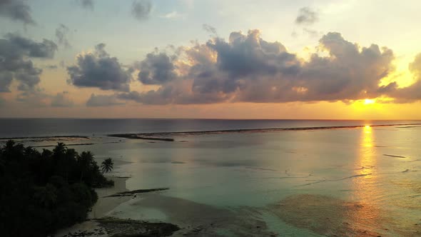 Tropical birds eye clean view of a summer white paradise sand beach and blue ocean background in 4K