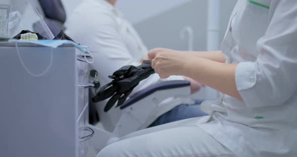 Doctor Puts on Sterile Gloves Before Treatment