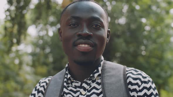 Portrait of Positive Afro-American Male Student Outdoors