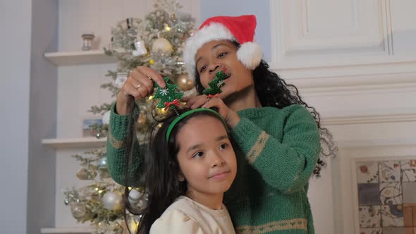 Mother Fixes Daughter Headband in Festive Atmosphere