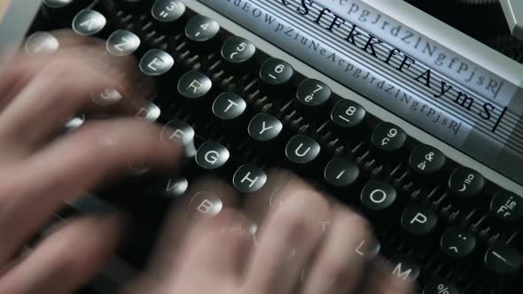 A man typing on a typewriter