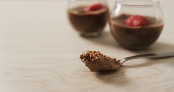 Video of chocolate pudding with strawberries and bluberries on a wooden surface