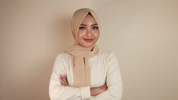 Cheerful young beautiful Asian Muslim woman smiling.