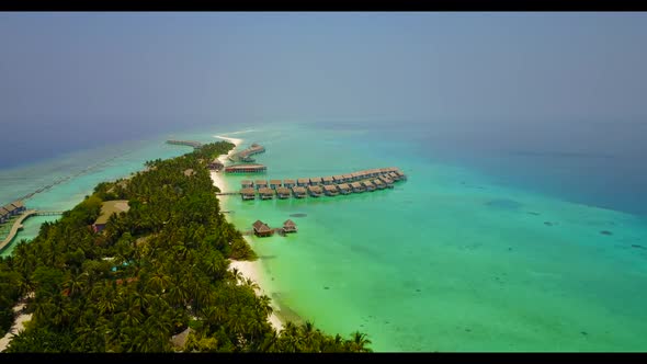 Aerial drone view tourism of relaxing seashore beach journey by blue water with white sandy backgrou