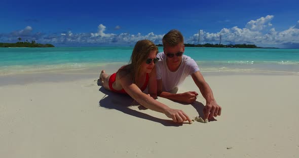 Fun man and woman after marriage in love have fun on beach on summer white sandy background 4K