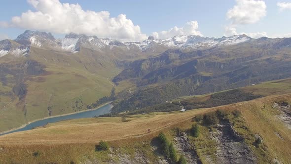 Aerial drone view of mountain biker biking in the mountains.