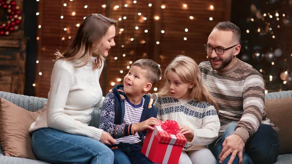 Kids and Parents Open Christmas Present Having Amazed Emotion