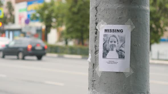 Leaflet About the Missing Child Hanging on a Pole