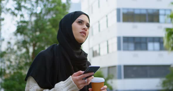 Woman in Hijab Using Mobile Phone 4k
