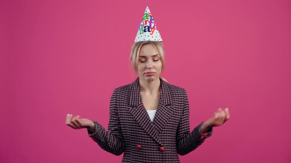 Depressed and Sad Young Woman with a Party Cone on Her Head Celebrates Depressed Unhappy