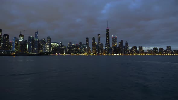 Dramatic Night Sky Above Chicago Downtown and Michigan Lake Lights on Waterfront