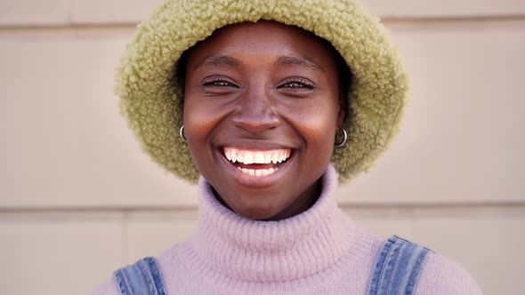 Outdoor Portrait of a Cheerful Black Woman Looking at the Camera Smiling