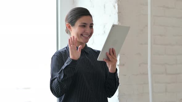 Indian Woman Standing and Doing Video Chat on Tablet 