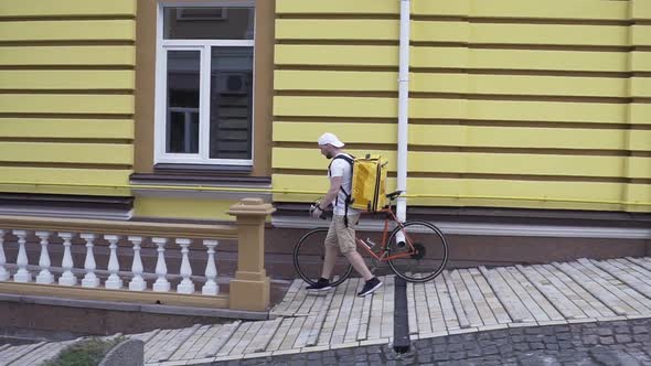 Delivery Man Arrives at Residential Address To Deliver Food Order To Customers