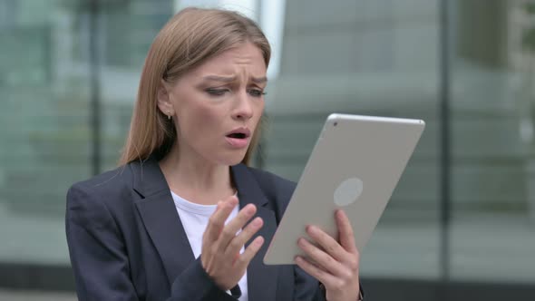 Young Businesswoman Having Loss on Tablet While Walking on the Street