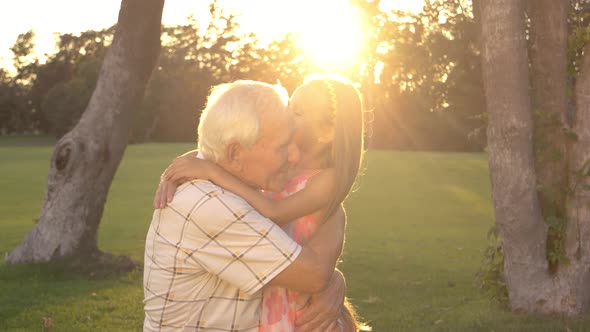 Happy Grandfather and Granddaughter Outdoors.