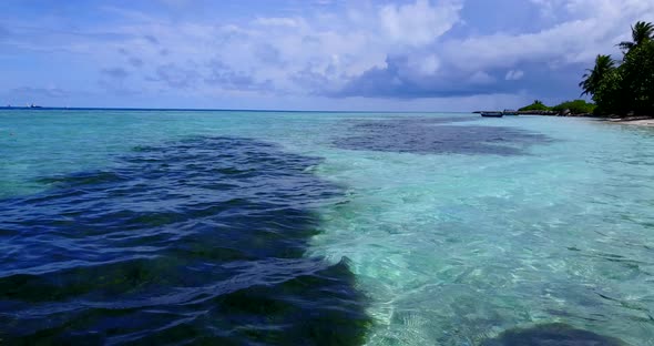 Daytime aerial abstract shot of a summer white paradise sand beach and blue ocean background 