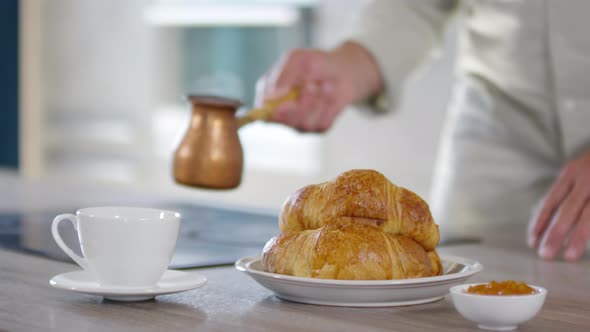 Unrecognizable Man Pouring Coffee from Cezve for Breakfast