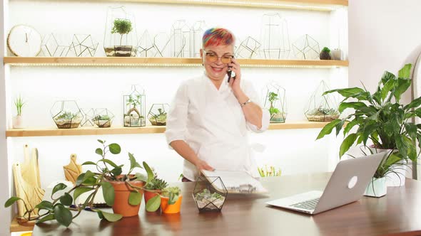 Female Florist Talk on Mobile Phone While Working