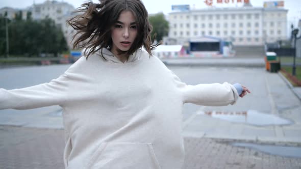 Pretty Brunette Is Looking at Camera While Walking